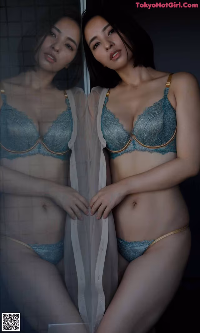 A couple of women standing next to each other in underwear.
