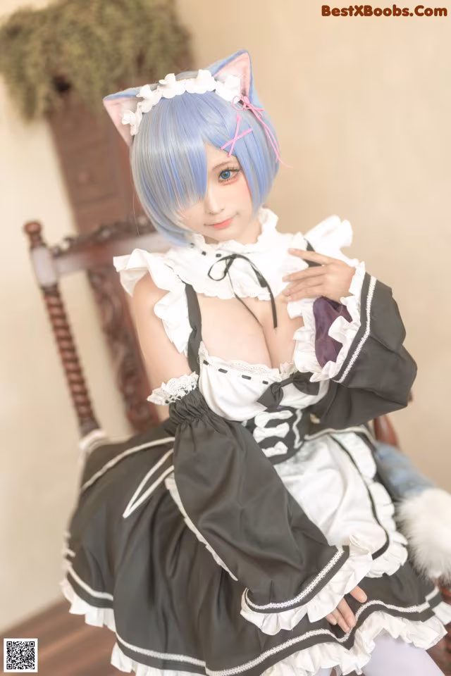 A woman in a maid outfit sitting on a chair.