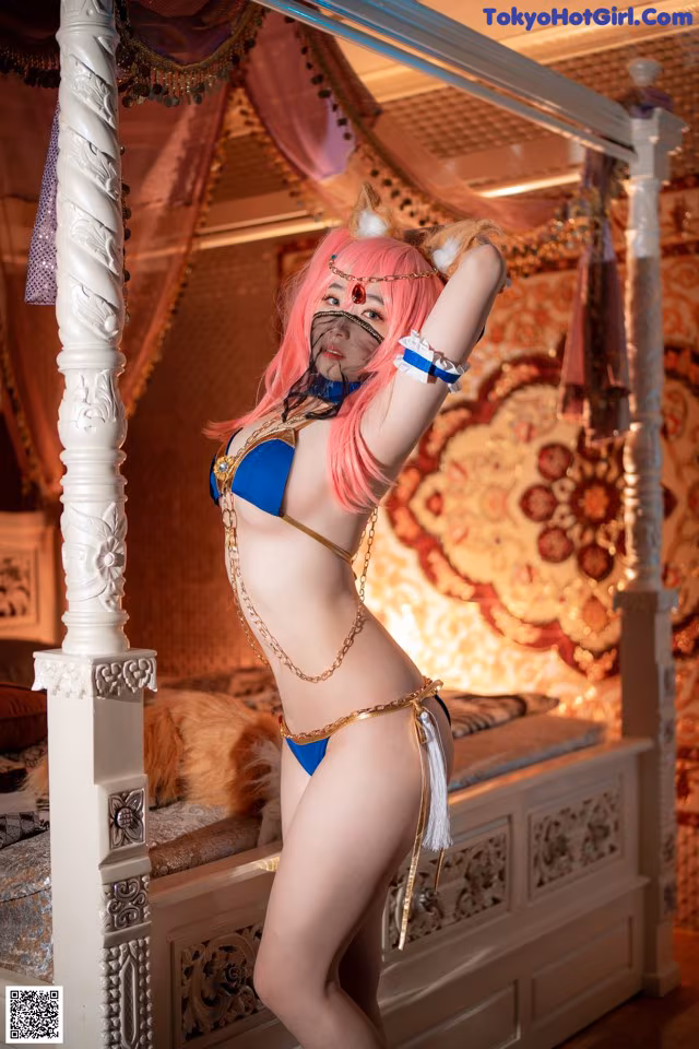 A woman in a bikini posing on a bed.