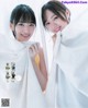 A couple of young women standing next to each other.