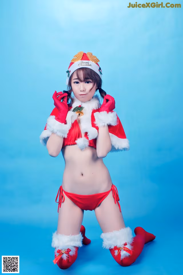A woman in a red bikini and a santa hat.