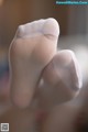 A close up of a person's feet in white socks.