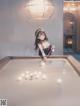 A woman is playing pool in a room.