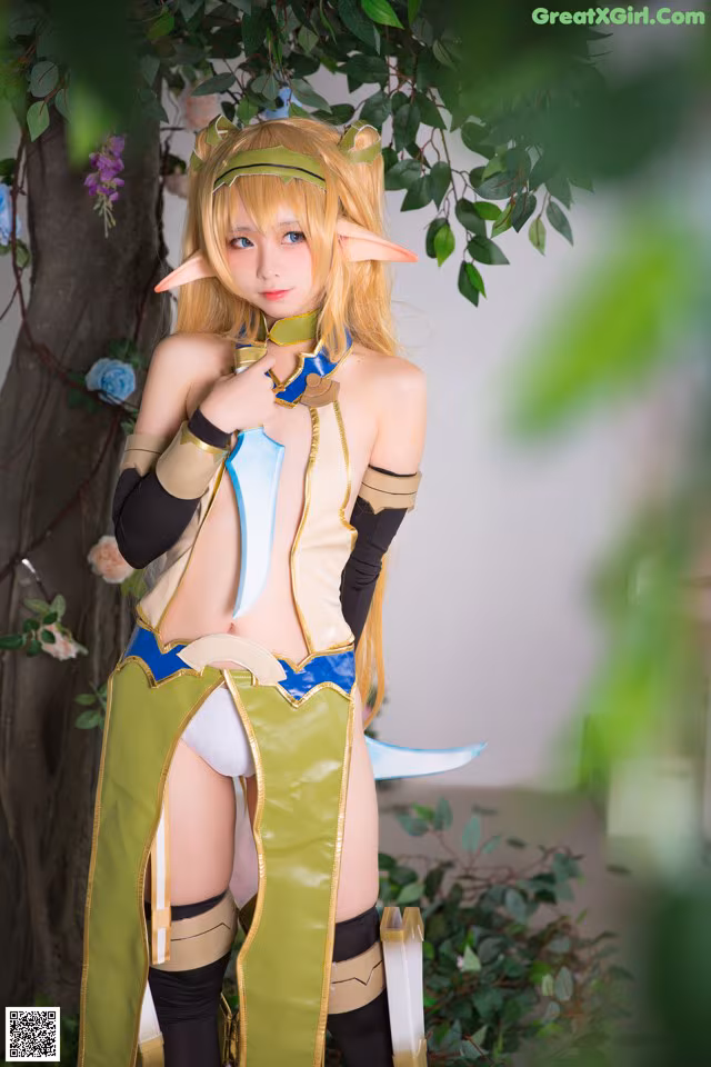 A woman dressed in a costume standing next to a tree.