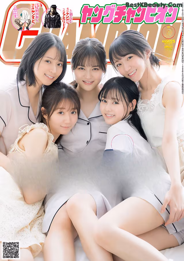 A group of young women sitting on top of a bed.