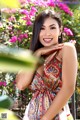 A woman in a colorful dress posing for a picture.